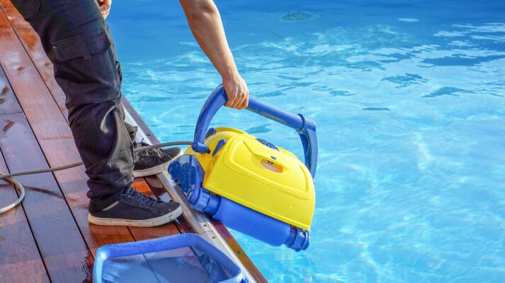 Pool maintenance essentials with clear water and tools.